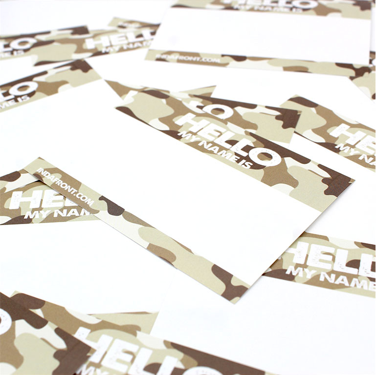 Hello My Name is Desert Camouflage Indafront graffiti blank sticker from close up laying crooked on same type of stickers