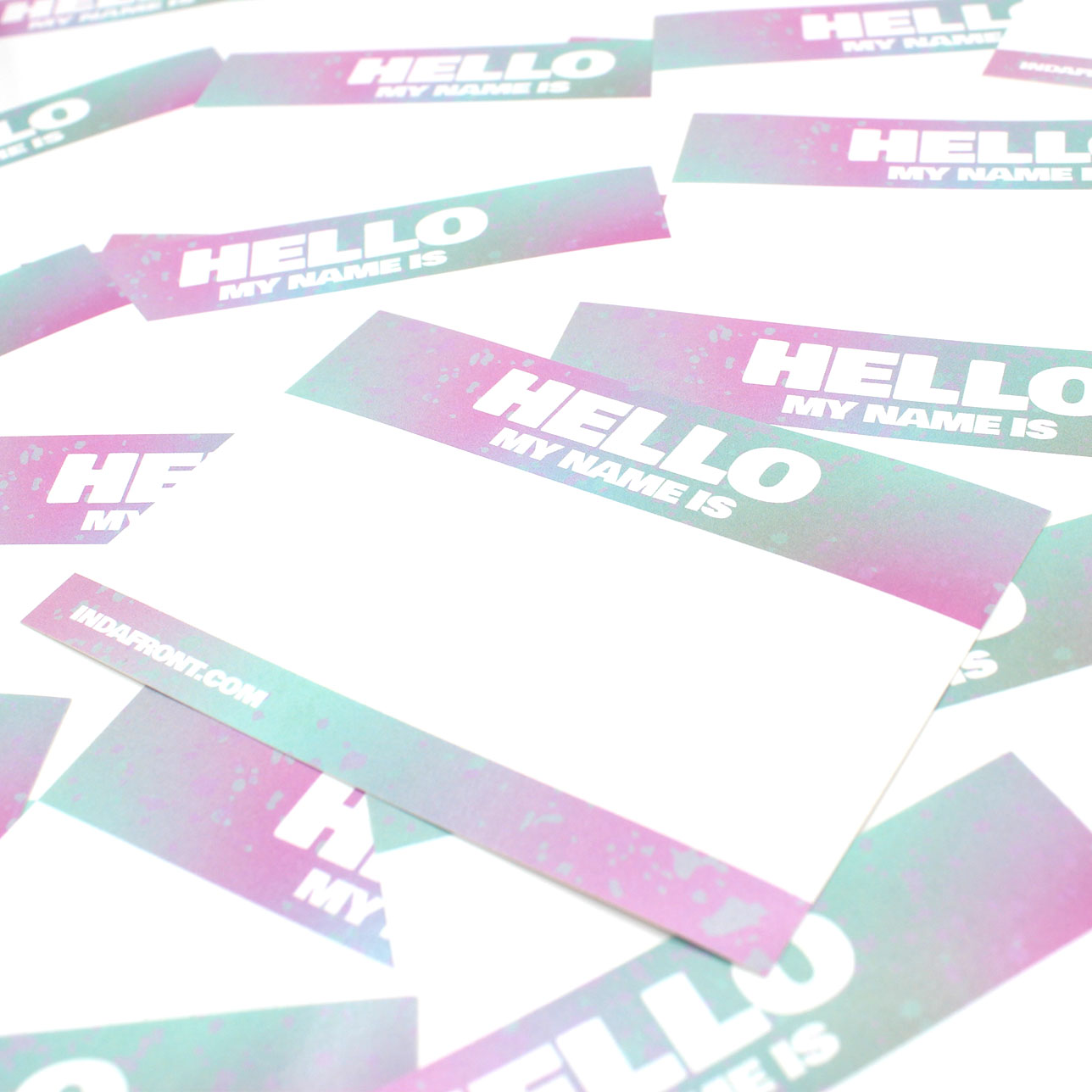 Close up Indafront Hello My Name is Pink vinyl gradient sticker laying crooked & horizontally on other stickers